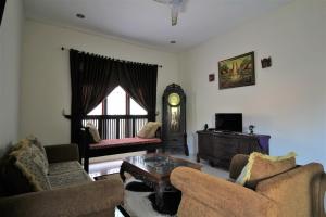 a living room with two chairs and a coffee table at Villadevi in Pangandaran