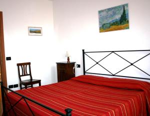 
a bed sitting in a bedroom next to a wall at Residence Podere Olmo in Sovicille
