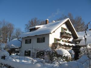 a house with snow on the roof at Martina's place in Rottenbuch