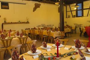 Gasthaus zum Ochsen في Westernhausen: غرفة مليئة بالطاولات والكراسي مع غطاء الطاولة الأصفر