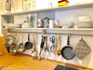 a bunch of utensils hanging from a kitchen shelf at Ladenwohnung in Kreuzberg mit Parkplatz in einer Tiefgarage in Berlin +16 photos