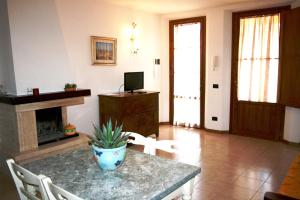 a living room with a table and a fireplace at Podere Olmo Adriano in Sovicille