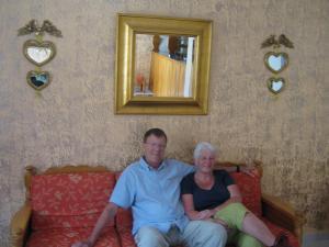 a man and a woman sitting on a couch at Amaryllis Hotel in Karpathos