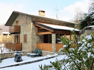 a house with a patio in the snow at Casa Martina in Zogno