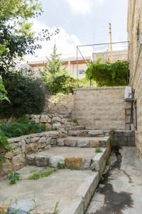 a set of stone steps next to a building at Mresty Guest House in Al Mţullah