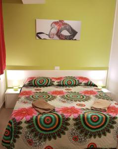a bedroom with a bed with a colorful bedspread at La Perla del Doge con Wellness & Spa uso esclusivo in Venice