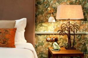 um quarto com uma cama e um candeeiro sobre uma mesa em Casa Oliver Boutique B&B - Principe Real em Lisboa
