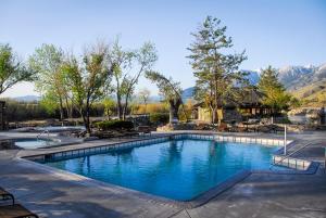 a swimming pool in a resort with mountains in the background at Holiday Inn Club Vacations - David Walley's Resort, an IHG Hotel in Genoa