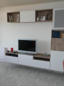 sala de estar con TV en una pared blanca en Duinenzicht, en Bredene