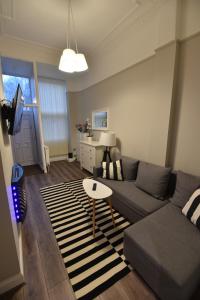 a living room with a couch and a table at Slateford House Apartment Ground Floor Main Door in Edinburgh