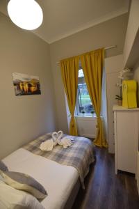 a bedroom with a bed with two towels on it at Slateford House Apartment Ground Floor Main Door in Edinburgh