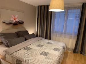a bedroom with a bed with a flower on the wall at Apartment City Center Prestige in Dresden