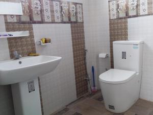 a bathroom with a toilet and a sink at Southceylon77 in Weligama +65 photos