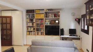 a living room with a couch and a tv at Appartamento Modena Park in Modena