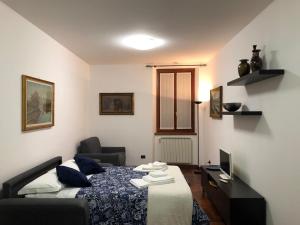 a bedroom with a bed and a desk and a television at "Your Home" Bergamo Centro in Bergamo