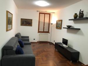 a living room with a couch and a television at "Your Home" Bergamo Centro in Bergamo