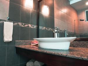 a bathroom with a white sink on a counter at Casa Caracol in Playa Coronado +53 photos