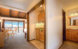 a kitchen with wooden cabinets and a dining room with a table at Elk Refuge Inn in Jackson