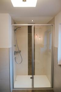 a shower with a glass door in a bathroom at Apart Julia in Längenfeld