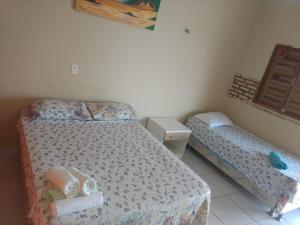 een kleine slaapkamer met 2 bedden en een raam bij Refúgio Canaã in Retiro Grande