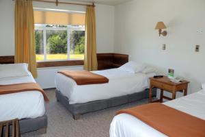 a hotel room with two beds and a window at Hotel Museo El Greco Puerto Varas in Puerto Varas +44 photos