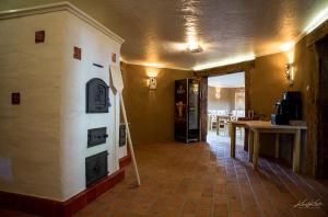 a room with a kitchen with a fireplace and a table at Siedlisko Wigry in Rosochaty Róg