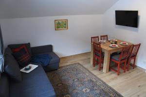 a living room with a couch and a table at Ausblick Appartements mit Lungaucard in Sankt Michael im Lungau