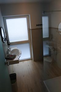 a bathroom with a sink and a large window at Ausblick Appartements mit Lungaucard in Sankt Michael im Lungau +37 photos