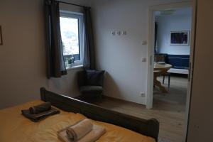 a bedroom with a bed and a large mirror at Ausblick Appartements mit Lungaucard in Sankt Michael im Lungau