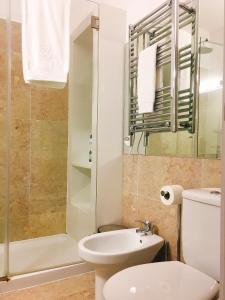 a bathroom with a toilet sink and a shower at Baixa Chiado Áurea Apartment in Lisbon