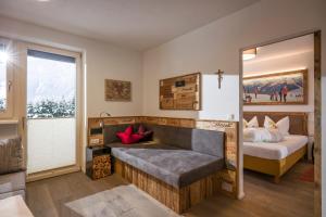 a bedroom with a bed and a large window at Royal Waldfeld in Mayrhofen