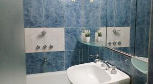 a bathroom with a sink and a tub and a mirror at Plaza Independencia in Mendoza +21 photos