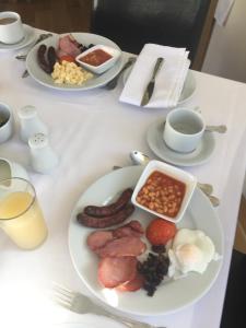 a table with plates of breakfast food on it at Gonalston Boutique B&B in Lowdham