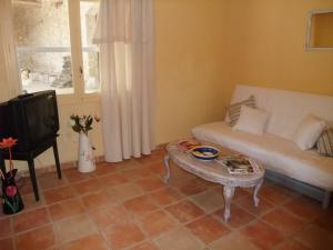 a living room with a couch and a coffee table at Mas Tolosan in Vauvert