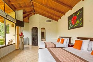 a bedroom with two beds in a room at Arenal Volcano Inn in Fortuna +51 photos