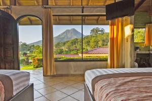 a hotel room with a view of the ocean at Arenal Volcano Inn in Fortuna