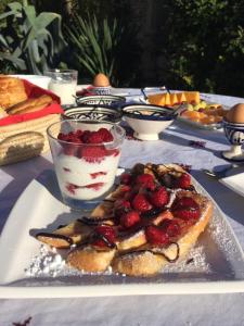 a table topped with a plate of food with a dessert at Mas Tolosan in Vauvert