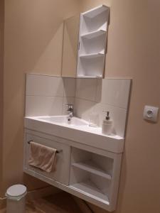 a bathroom with a white sink and a mirror at Le Gîte de la Maison Soleil, entre lac et montagne in Alex +11 photos