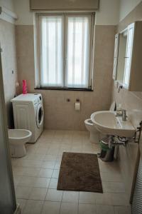 a bathroom with a sink and a washing machine at Giada Rooms in Peschiera del Garda