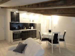 a kitchen and dining room with a table and chairs at Apartments Žera in Vlasic