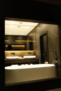 a bathroom with two sinks and a mirror at Hotel Rubis in Ferizaj