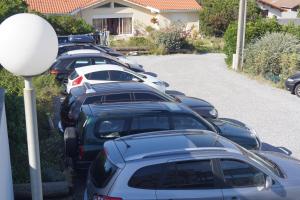 a row of cars parked in a parking lot at Appartements Les Déferlantes Mimizan-plage in Mimizan-Plage