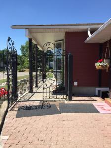a gate to a red house with flowers on it at The Calgary Hub hostel style Home in Calgary