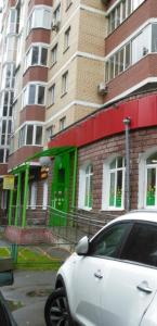 a white car parked in front of a building at Hotel Siesta in Lyubertsy