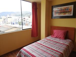 a bedroom with a bed and a large window at Hotel Caxa Wasi in Cajamarca +37 photos
