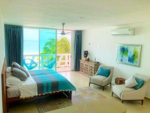 a bedroom with a bed and a view of the ocean at Playa 55 beach escape - adults only Guesthouse in Celestún