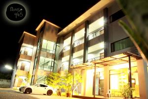 a white car parked in front of a building at night at House 945 in Khon Kaen