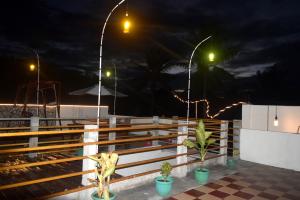 a wooden fence with two lights on it at night at Panda Cottage in Gili Trawangan