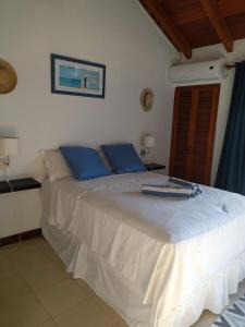 a bedroom with a large white bed with blue pillows at Simpson Bay Yatch Club 2 Bedrooms in Simpson Bay