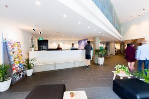 a lobby of a store with people waiting at the counter at Song Hotel Sydney in Sydney